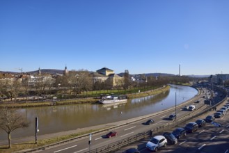 Long shot, Saarland State Theatre, general architecture, Saar river, streets, cars, trees, parking