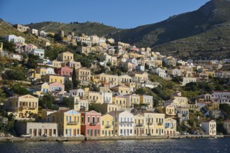 Colourful houses on a hilly shore, Symi Town, Symi, Dodecanese, Greek Islands, Greece, Europe