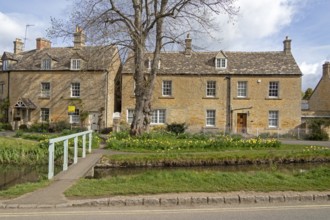 Honey-coloured houses, bridge, River Eye, Lower Slaughter, The Cotswolds, Gloucestershire, England,