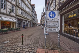 Pedestrian zone, café, furniture shop, pub, half-timbered houses, bollards, diffuse light, cloudy,