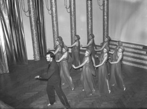 Ballet girls in on stage 1939. The young women are all dressed in their costumes with a man in