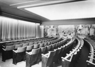 Emtpy chairs. A picture from a movie theatre with empty seats. The rows of chairs are numbered so