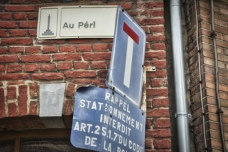 Liege, Belgium, June 2021: Street sign of Au Peri in Liege on a brick wall. Close-up and detail,