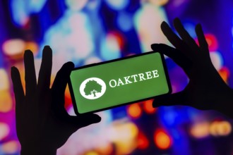 In this photo illustration, the Oaktree Capital Management logo is displayed on a smartphone screen