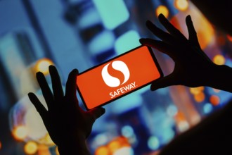 In this photo illustration, the Safeway logo seen displayed on a smartphone