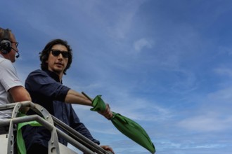 Honorary starter, Adam Driver, prepares to drop the green flag for the Indianapolis 500 in