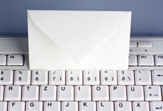 The keyboard of a computer and an envelope. Communication via e-mail, The keyboard of a computer