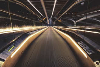Symmetrical escalator with illuminated handrail in modern surroundings, Liège-Guillemins railway