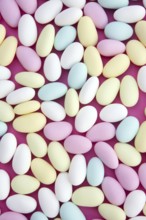 Sugared almond sweet candy pastel colorful on soft pink