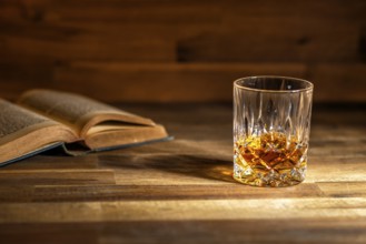 A glass of rum and an old book in a bar in Cuba