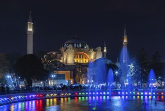 A picture of the Hagia Sophia and the colorful Sultan Ahmet Park Fountain at night