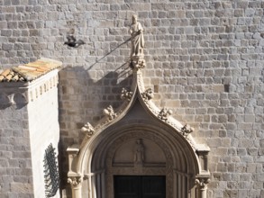 Sculpture, stone carving, figure of a saint above a church portal, Old Town of Dubrovnik, Dalmatia,