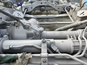 Detailed view of gearbox and mechanical parts of a vehicle in a workshop