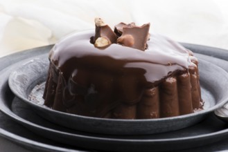 Chocolate pudding with chocolate dressing on a plate