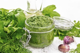 Sauce of dill, parsley, basil, cilantro, other spicy herbs, garlic and vegetable oil in a glass