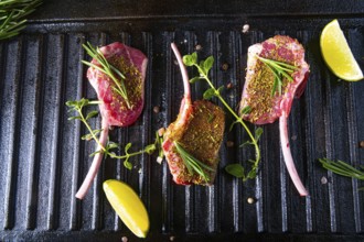 Seasoned and herb-marinated raw lamb chops