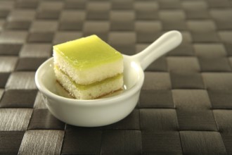 Varied pastries over spoon. Little colorful cakes