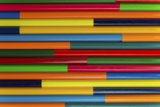 Collection of coloured pencils in a horizontal complementary colors set up as background picture