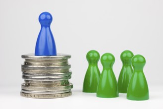Conceptual financial position represented with colored play pieces and coins