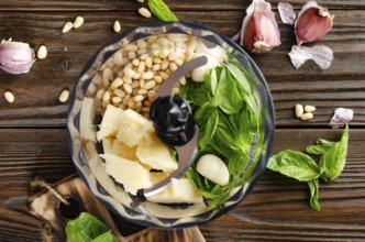 Ingredients for italian national traditional genovese pesto sauce in food processor bowl. Flat lay