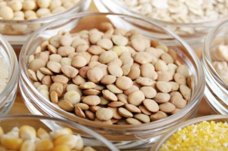 Lentils closeup in glass bowl on wooden kitchen table, non-perishable, long shelf life food concept