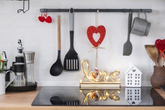 The interior of the kitchen in the house is decorated with red hearts for Valentine's Day. Decor on