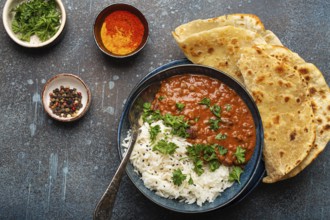Traditional Indian Punjabi dish Dal makhani with lentils and beans in black bowl served with