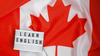 The National Flag of Canada. Lightbox with text LEARN ENGLISH Canadian Flag or the Maple Leaf.