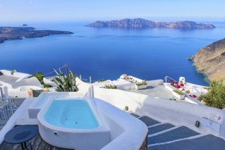 White buildings and hotels with panoramic view of Aegean Sea in Fira, Santorini, Greece, Europe