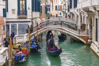 Gondola, the traditional Venetian boat, on canal with tourists, Venice, Italy, Europe