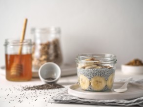 Healthy breakfast concept and idea - chia pudding with organic banana and bee pollen. Glass jar