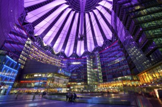 Sony Center in Berlin at night with purple lights on the ceiling