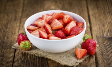 Fresh made Chopped Strawberries on a vintage background as detailed close-up shot