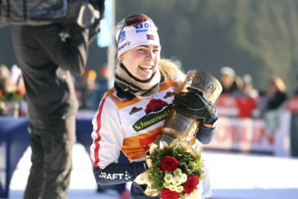 Ida Marie Hagen Norway lifts the Black Forest Cup at the award ceremony for the FIS Nordic Combined