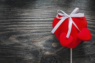 Red fabric hearts on wooden board celebrations concept