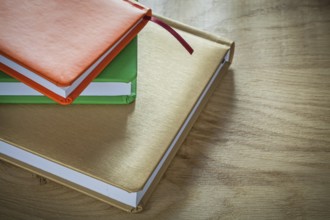 Stack of office notebooks on wooden board