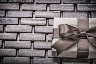 Present with ribbon on wooden mat horizontal view holidays concept
