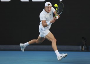 Danish tennis player Holger Rune playing a backhand shot at the Australian Open 2025 tournament,