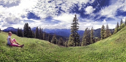 Girl in a meadow with the Blaubergalm, Tyrol, Austria Girl in a meadow with the Blaubergalm,