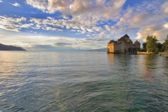 A medieval fortress ?hillon on lake Leman on a sunset