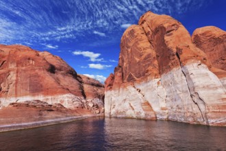 Lake Powell is surrounded by magnificent red hills. Walk on the boat at sunset. Scenic huge