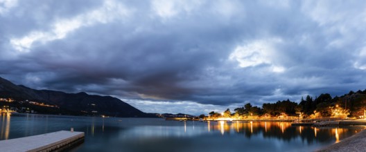 Morning atmosphere in front of sunrise at the sea, jetty in the blue hour in the morning, long