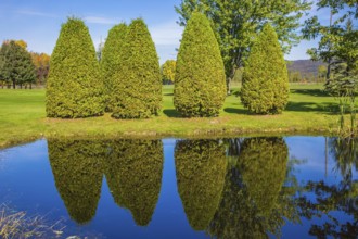 Autumn in French Canada. Concept of recreational tourism. Small pond with water mirror reflecting