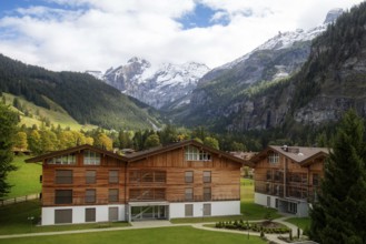 Wooden chalet in Kandersteg village, Canton Bern, Switzerland, Europe, Autumn trees and mountains