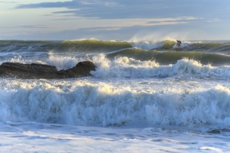 Surfer in action on the ocean waves on a sunny day in France