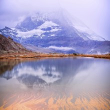 Colorful pink sunrise and reflection of Matterhorn mountain at Riffelsee lake, Zermatt Switzerland