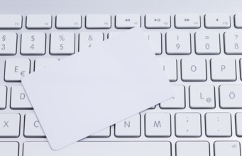 White keyboard with a blank white pastille card