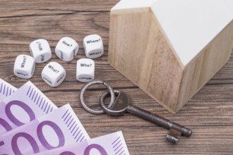 The photo shows a model house with various question cubes and a key