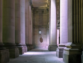 The entrance of the historic 19th century leeds city hall building illuminated at night