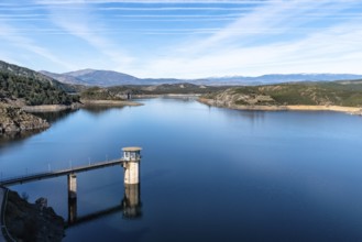 The Atazar reservoir and control tower of Dam in the mountain range of Madrid